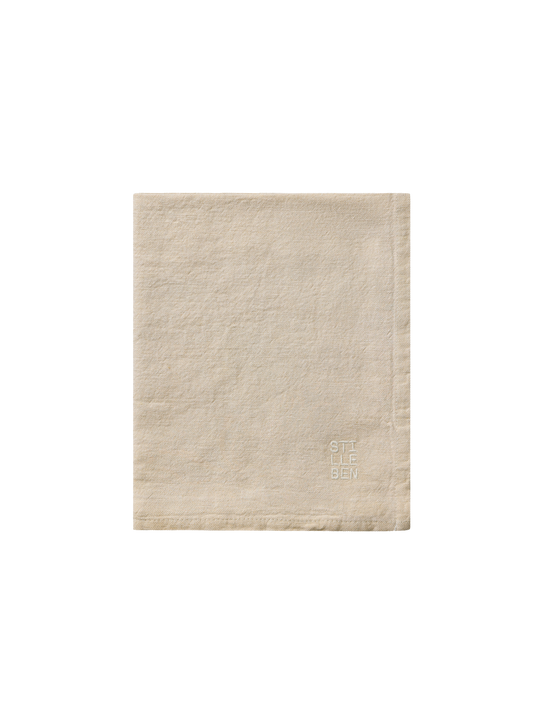 tea towel in sand