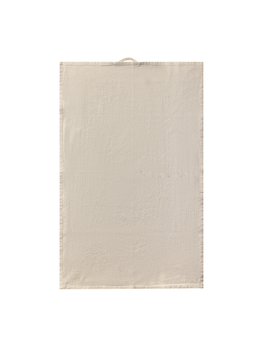 tea towel in sand